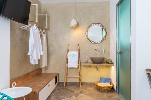 a bathroom with a ladder and a sink and a mirror at Vintage Suites in Limenaria