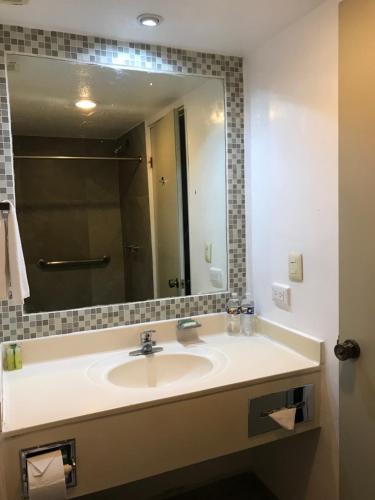 a bathroom with a sink and a large mirror at Hotel Parque Central in Monterrey