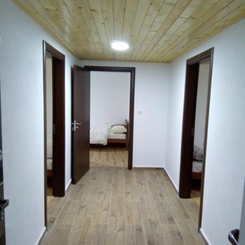 a hallway with doors open to a bedroom at Bujtina Sherifaj in Valbonë