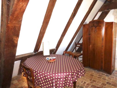a table in a room with a red and white table cloth at Château d'Avanton in Avanton