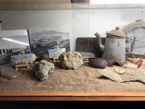a group of artifacts sitting on top of a table at Amargosa Opera House & Hotel in Death Valley Junction