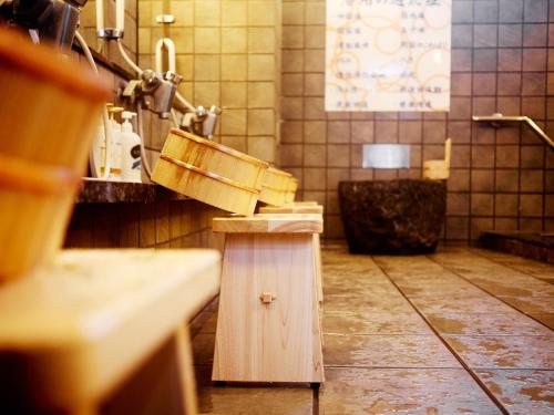 a bathroom with a sink and a tub at Super Hotel Hirosaki in Hirosaki