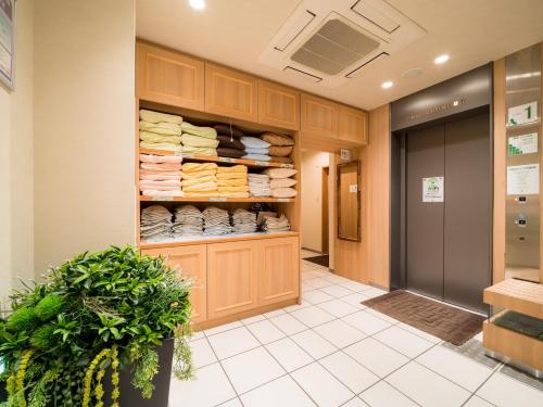 a store hallway with a closet with towels at Super Hotel Hirosaki in Hirosaki