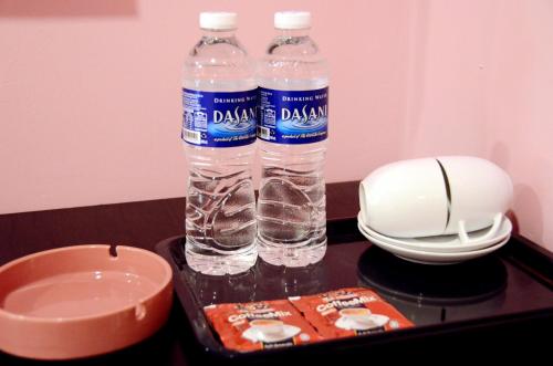 two bottles of water sitting on top of a table at Hotel Sri Rembia in Malacca