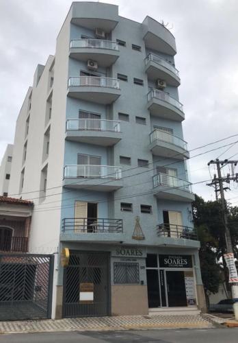 a tall building with balconies on the side of it at Pousada Soares in Aparecida