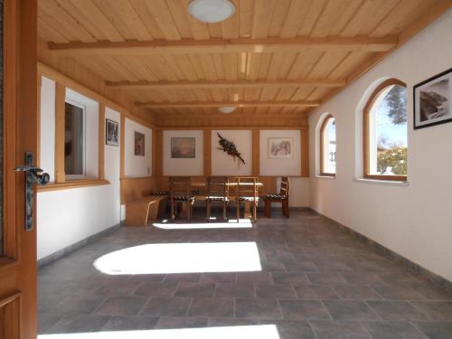 a room with a table and chairs and windows at Ferienhaus Inge in Sankt Leonhard im Pitztal