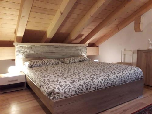 a bedroom with a large bed in a attic at HartlHof in Proves