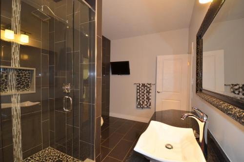 a bathroom with a shower and a sink at The SoMa Furnished Residences in Hamilton