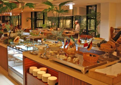a buffet line in a restaurant with food on display at Palace In Moon Beach in Onna