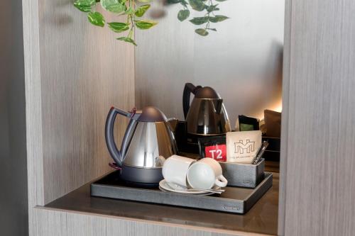 a shelf with a tea kettle and cups on it at The Melbourne Hotel in Perth