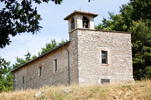an old stone building with a bell tower on top at Casa Vacanze Antico Poggio in Poggio San Giovanni