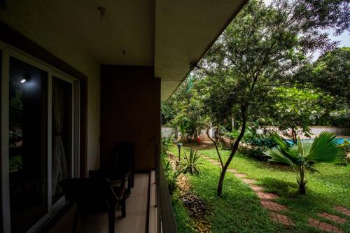 a view of a yard from a house at Ivy Retreat- Serviced Apartments in Baga