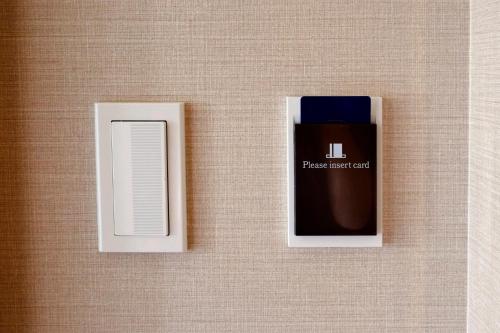 a box ofrax incentedents on a wall at Hotel Monte Hermana Kobe Amalie in Kobe