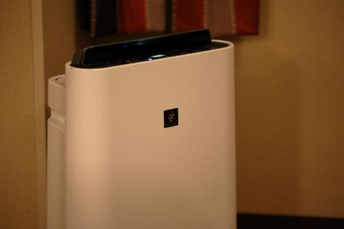a white refrigerator with a phone on top of it at Hotel Monte Hermana Kobe Amalie in Kobe