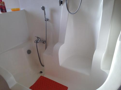 a bathroom with a shower with a red stool at Villa Mara in Riccò del Golfo di Spezia