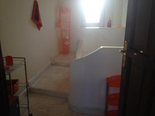 a bathroom with a bath tub and a window at Villa Mara in Riccò del Golfo di Spezia