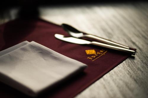a pair of scissors sitting on top of a table at Shinnabhura Historic Boutique Hotel in Phitsanulok