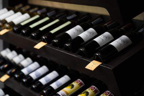 a bunch of bottles of wine on display at Shinnabhura Historic Boutique Hotel in Phitsanulok