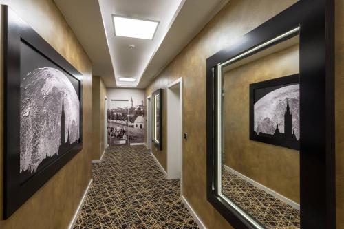 a hallway with paintings on the walls at Hotel Grand in Čáslav