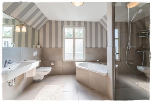 La salle de bains est pourvue d'une baignoire, d'un lavabo et de toilettes. dans l'établissement Ferienhaus Malve in Liepe, à Rankwitz