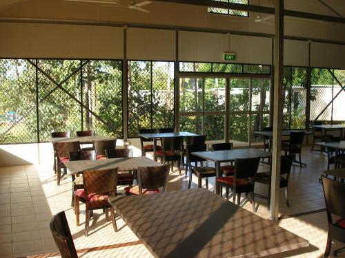 a dining room with tables, chairs, and tables at Pandanus on Litchfield in Batchelor
