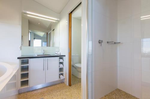 a bathroom with a shower and a sink and a toilet at Aquatic Visions in Margaret River Town
