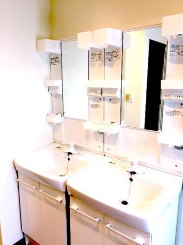 a bathroom with two sinks and a mirror at Tokyo Art House in Tokyo