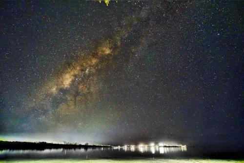 a starry night with the milky way over the water at Ocean Star Hotel in Koror