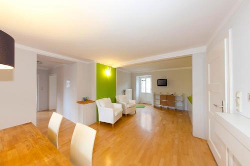 a living room with white furniture and green walls at Zeitraumferien in Bernau am Chiemsee