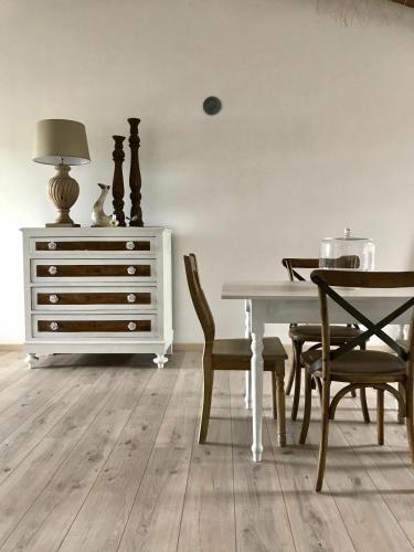 a dining room with a table and a dresser at Castel Apartment in Castellamonte