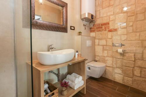a bathroom with a sink and a toilet at Luxury Rooms Dino in Split