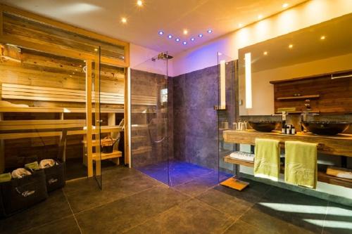 a bathroom with a shower and a sink at Sporthotel Cinderella in Obertauern