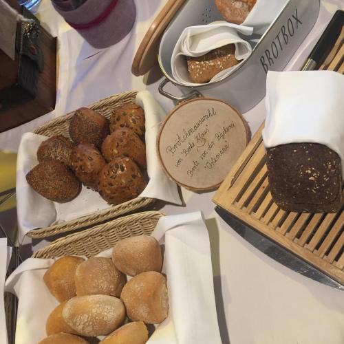 two baskets of bread and pastries on a table at Hotel Restaurant Der Engel, Sasbachwalden in Sasbachwalden