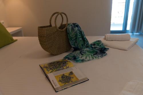 a table with a book and a bag and a pamphlet at Kiperi Exclusive in Parga