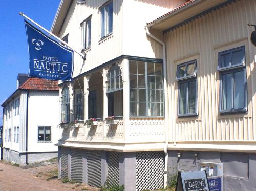 a white building with a sign on the side of it at Nautic Hotell in Marstrand