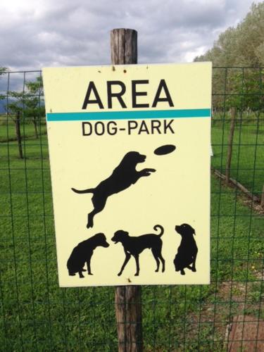 a sign for a dog park on a fence at Agriturismo Settepassi Tuscany in Ponte Buggianese