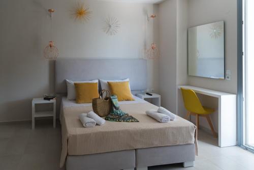 a bedroom with a bed and a yellow chair at Kiperi Exclusive in Parga