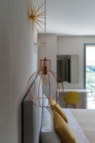 a glass lamp sitting on a bed in a bedroom at Kiperi Exclusive in Parga