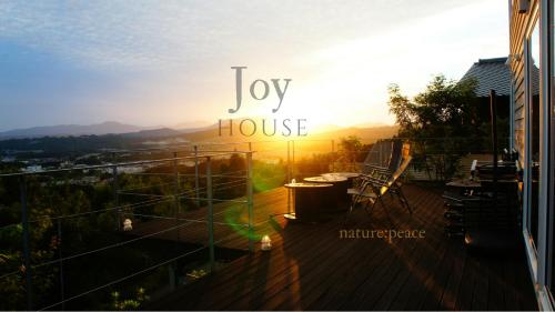 a balcony with a view of a house with the words joy house at Joy House in Imari