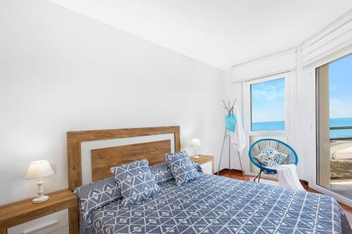 a bedroom with a bed and a view of the ocean at Santa Susanna Skyline Apartment in Santa Susanna