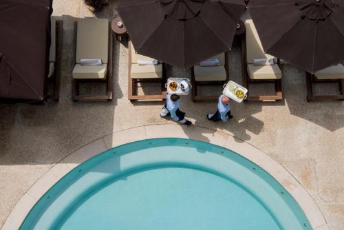 an overhead view of a pool with chairs and umbrellas at Capri Tiberio Palace in Capri