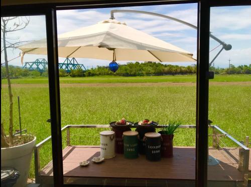 a table with an umbrella and some plants at Zebra Babala B&B in Dongshan