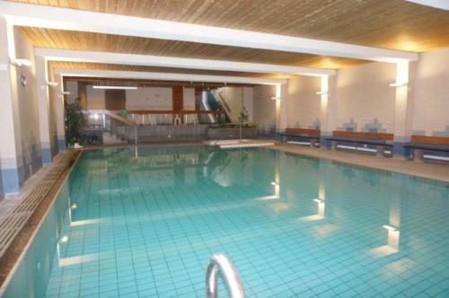 a large swimming pool in a building at Paradies 503 in Arosa