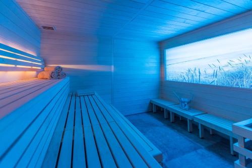 a sauna with two benches and a window at Dorint Seehotel Binz-Therme in Binz
