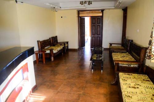 a room with chairs and tables and a fireplace at Regency Mount Kenya Hotel in Timau
