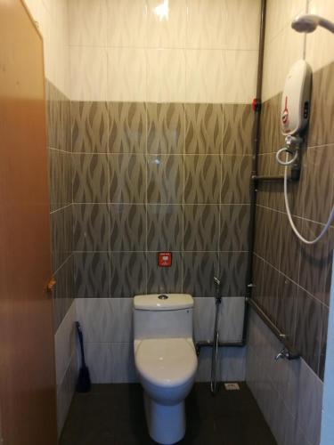a bathroom with a toilet and a shower at Coral Home 珊瑚之家 in Semporna