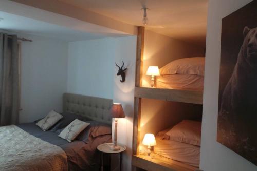 a bedroom with two bunk beds and a lamp at Spacious and stylish flat at the foot of the Mont-Blanc ideal for ski in ski out in Les Houches