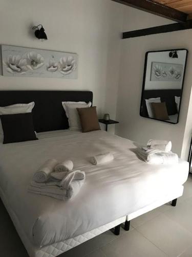a white bed with towels and shoes on it at Casa di a Restonica in Corte