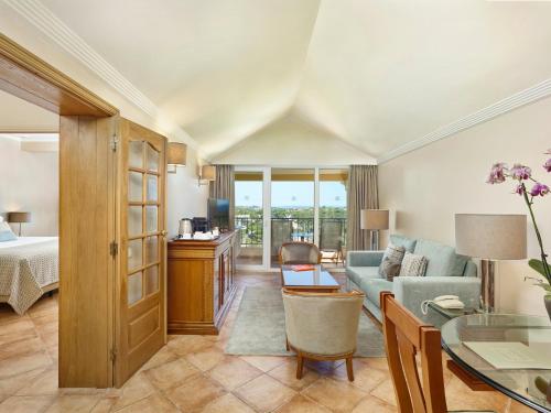 a living room with a couch and a table at Ria Park Hotel & Spa in Vale do Lobo