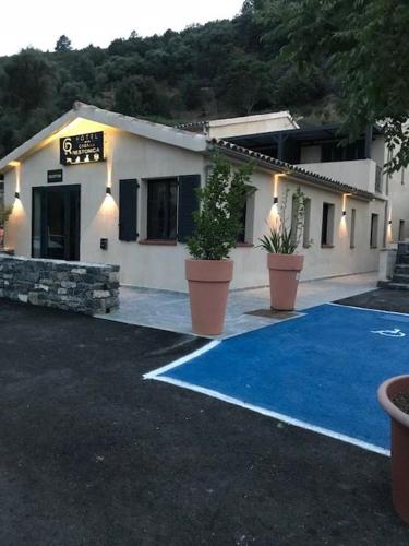 a building with two potted plants in front of it at Casa di a Restonica in Corte
